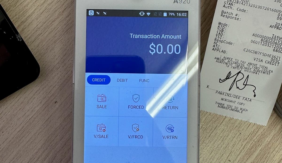 Payment terminal beside a printed transaction receipt