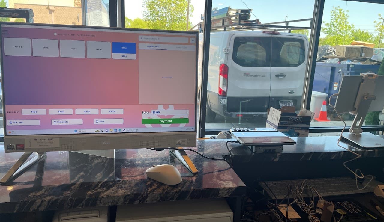 Merchant checkout station with point-of-sale screen and payment equipment