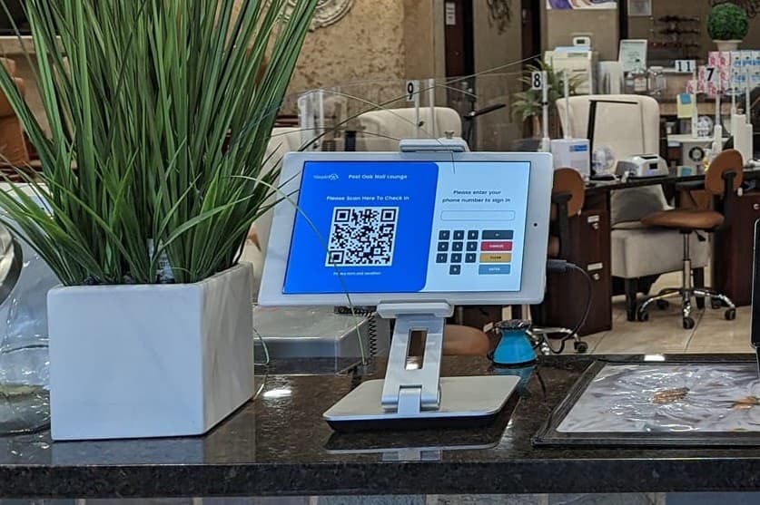 Customer check-in tablet installed at a salon counter