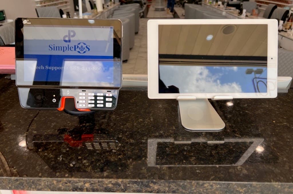 Payment terminal and customer-facing tablet at a merchant counter